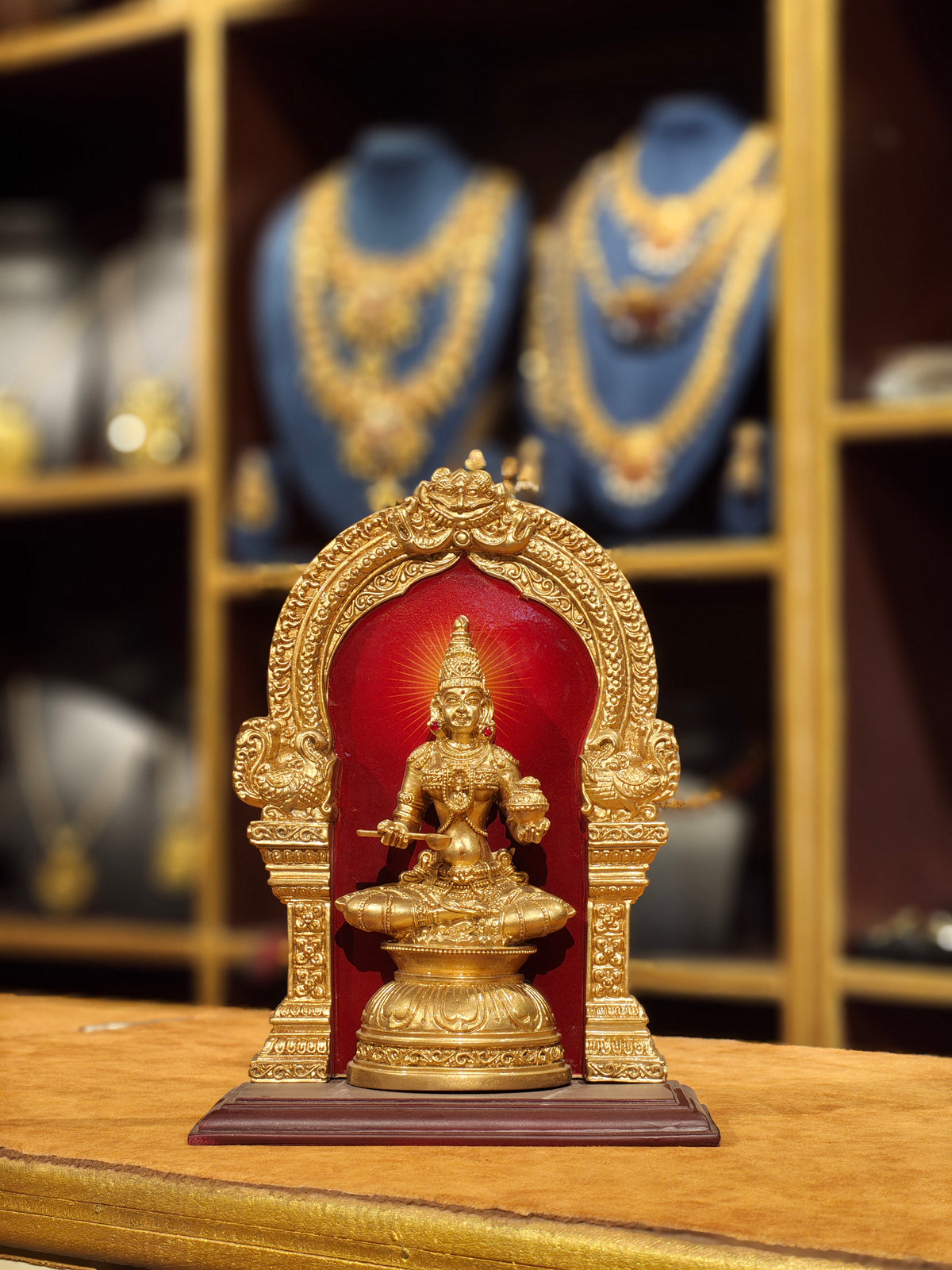 Goddess Annapurna Statue in Crimson Temple Arch – Gold Plated Pooja Idol