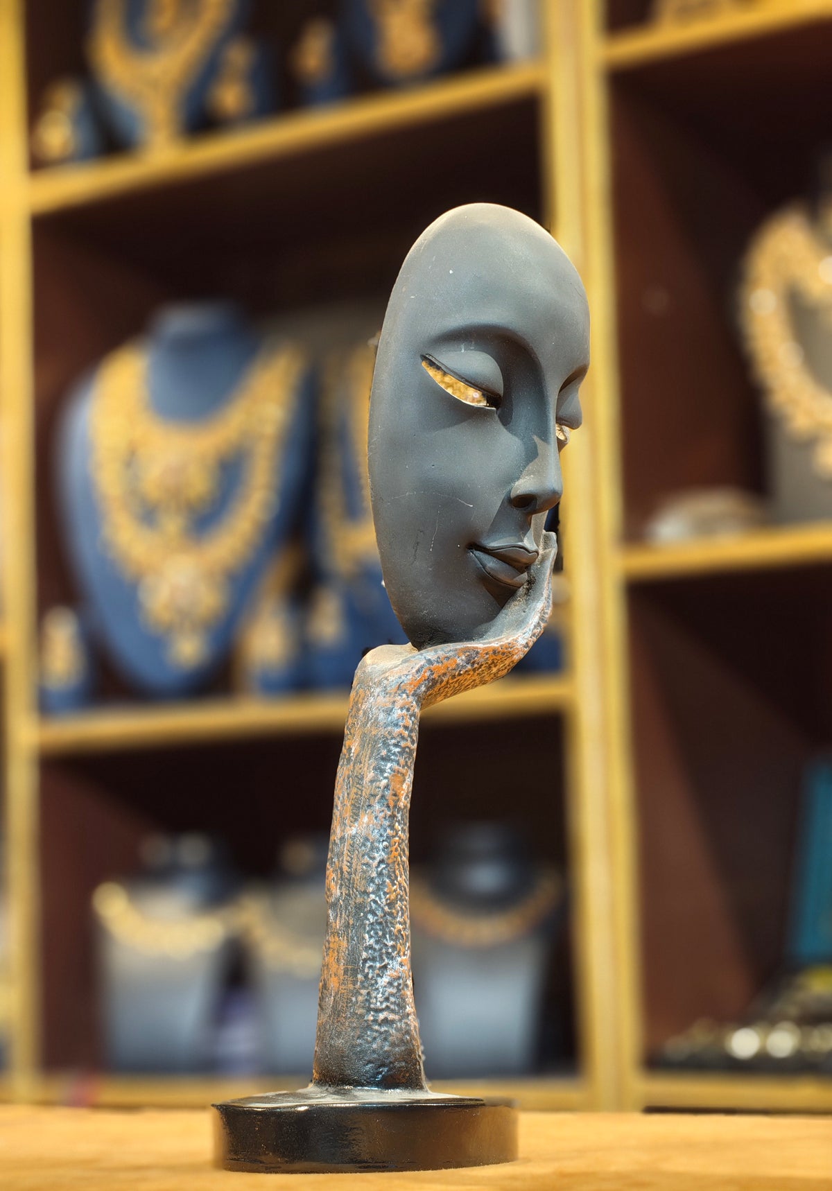 Modern Abstract Serene Face on Hand Sculpture – Matte Black & Textured Bronze Contemplation Figurine