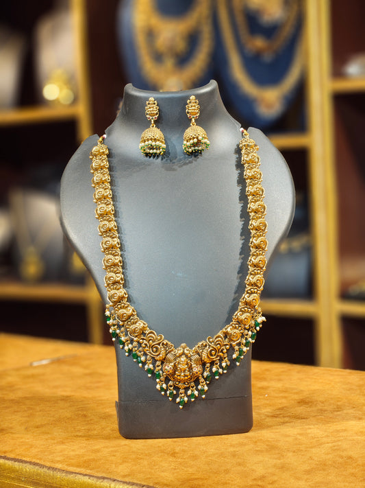 Antique Matte Gold Peacock Nakshi Temple Long Haram with Matching Jhumkas – Goddess Lakshmi Motif & Emerald-Pearl Droplet Fringes